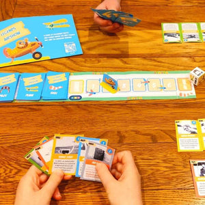 Paper Adventures Legends Airshow boardgame : Fun print-at-home activity for curious children. Perfect for quality family time, educative play & rainy days. Relive the most exciting airshow in history by creating your very own board game. Children playing game on table.